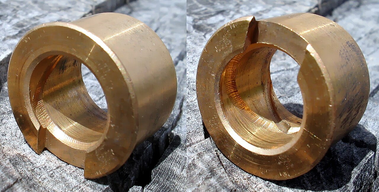 Two bronze plain bushes with internal spiral oil grooves for a gearbox secondary shaft